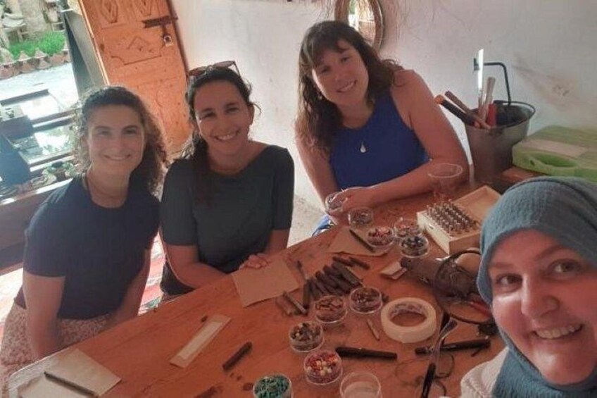 Three people sitting at a table with various food items and utensils. 1