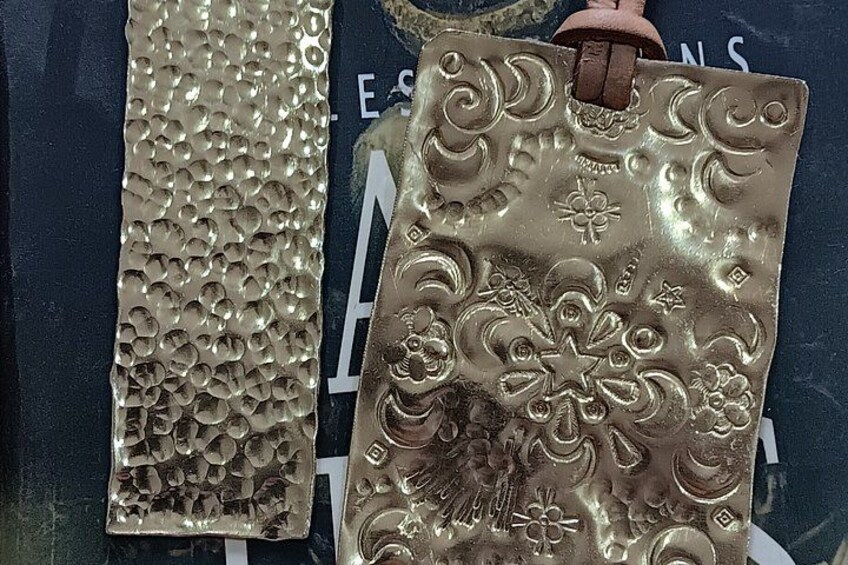 Two metallic decorative items with embossed patterns. 5