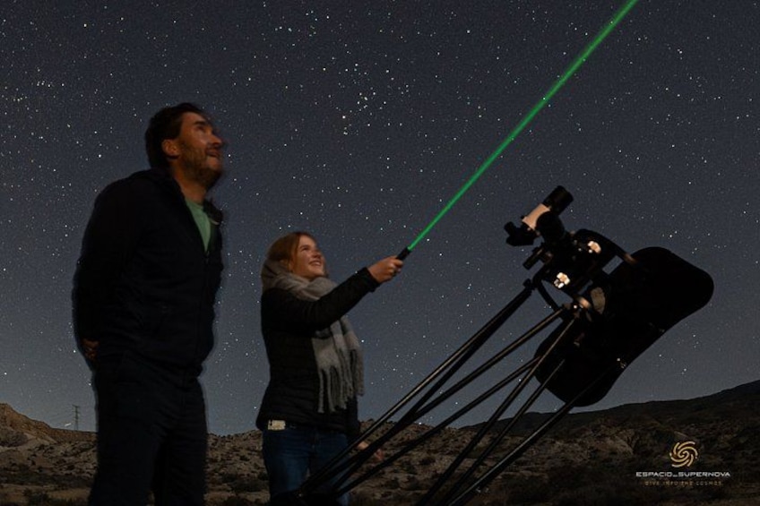 Two people observing the night sky with a telescope. 5