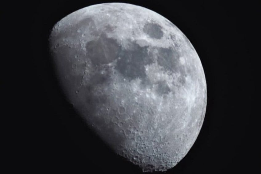 A detailed view of the moon's surface with visible craters and lunar maria. 2