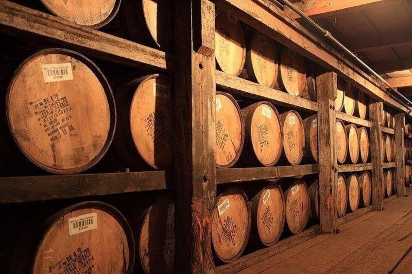 Wooden barrels stacked in a warehouse. 2