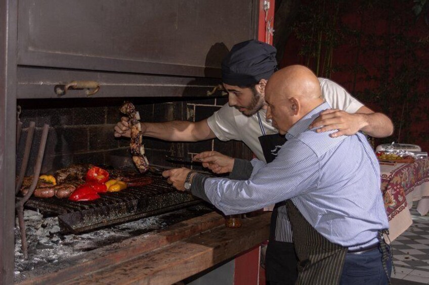 A person grilling meat on a barbecue. 3