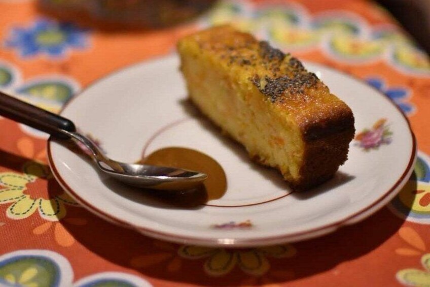 A slice of cake on a plate with a spoon. 2