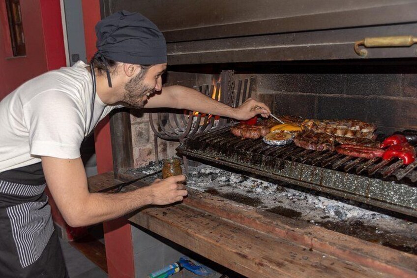 A person grilling food on an outdoor grill. 4