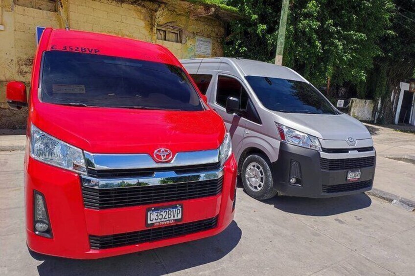 Two Toyota vans parked on a concrete surface. 4