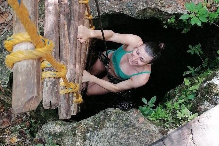 A person climbing a wooden structure with ropes. 5