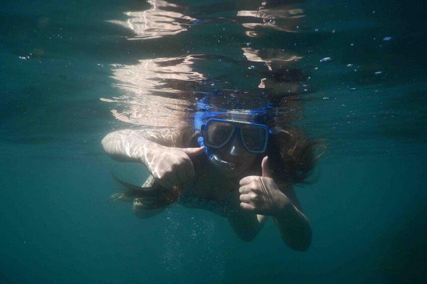 A person underwater giving a thumbs-up. 3
