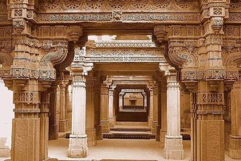 An intricately carved stone structure with multiple arches and columns. 1