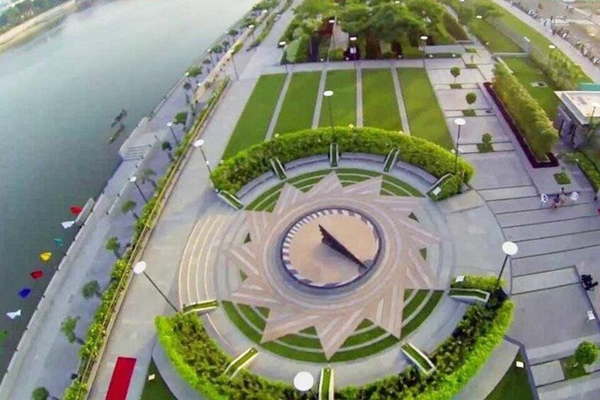 A circular park with a central fountain, surrounded by pathways and greenery. 2
