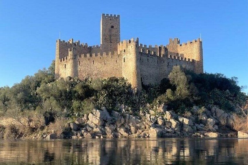 A medieval castle on a hill overlooking a body of water. 3