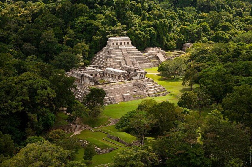 A large ancient pyramid complex surrounded by dense forest. 1