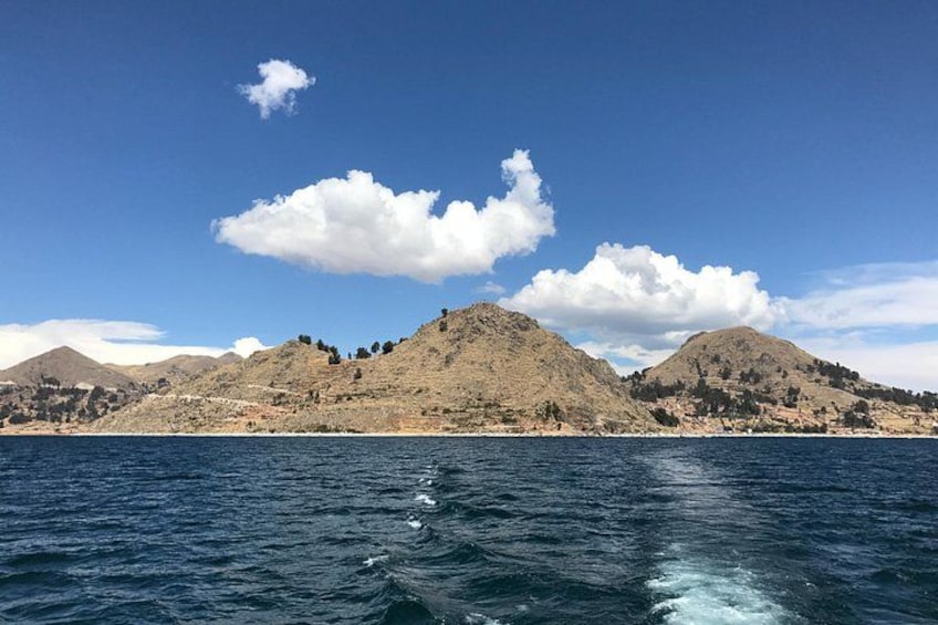A coastal landscape with hills and a body of water. 4