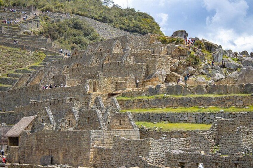 Ancient stone ruins with stepped terraces and stone walls. 4