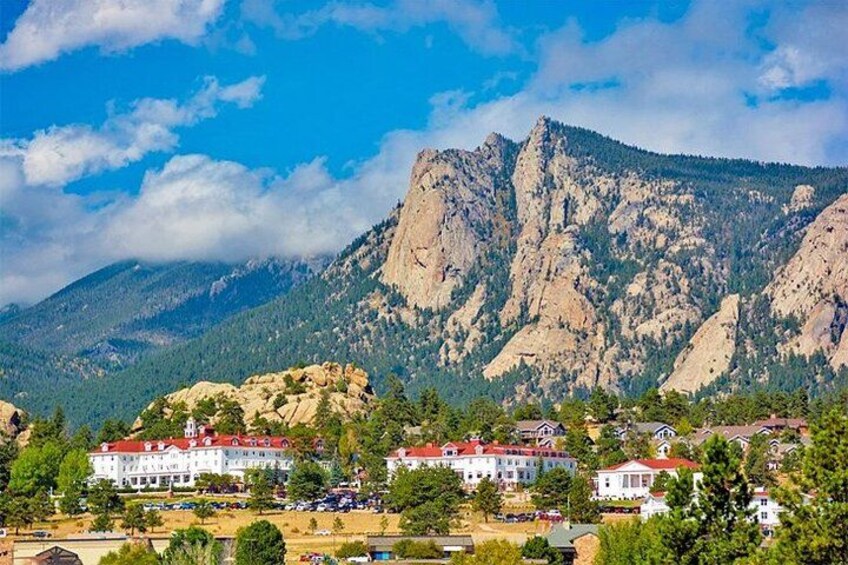 A mountainous landscape with a village and buildings with red roofs. 5