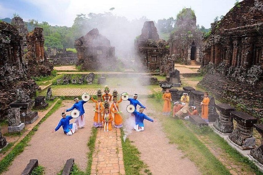 Ancient ruins with people in traditional attire. 5