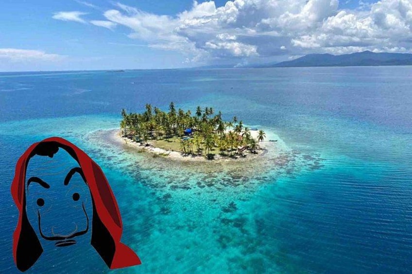 A tropical island surrounded by clear blue waters. 1