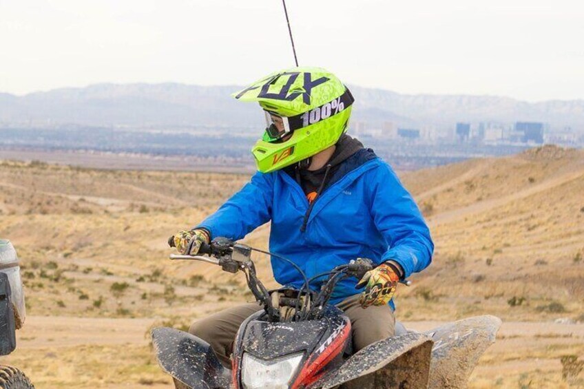 A person riding a motorcycle in a desert landscape. 2