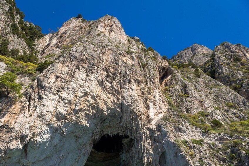 A rugged mountain with a cave entrance. 2
