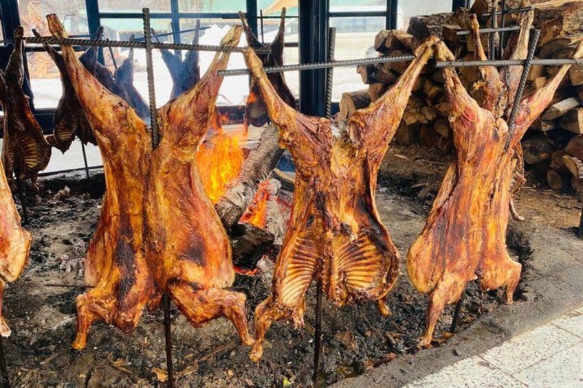 Des cochons entiers, rôtis et suspendus au-dessus d’un feu de bois. 2