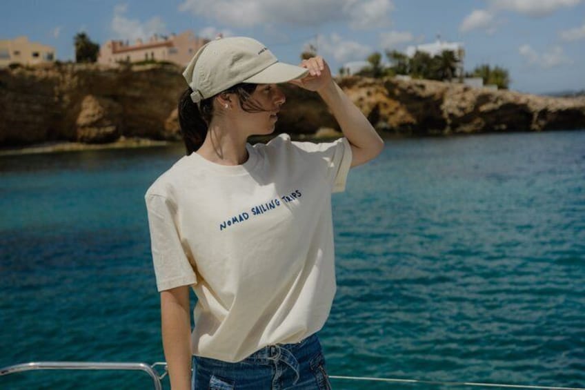 A person on a boat wearing a white t-shirt with 'NOAA SAILING' printed on it. 2