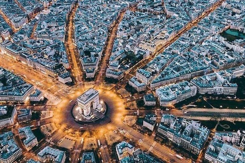 An aerial view of a city with a central monument surrounded by a circular road. 2