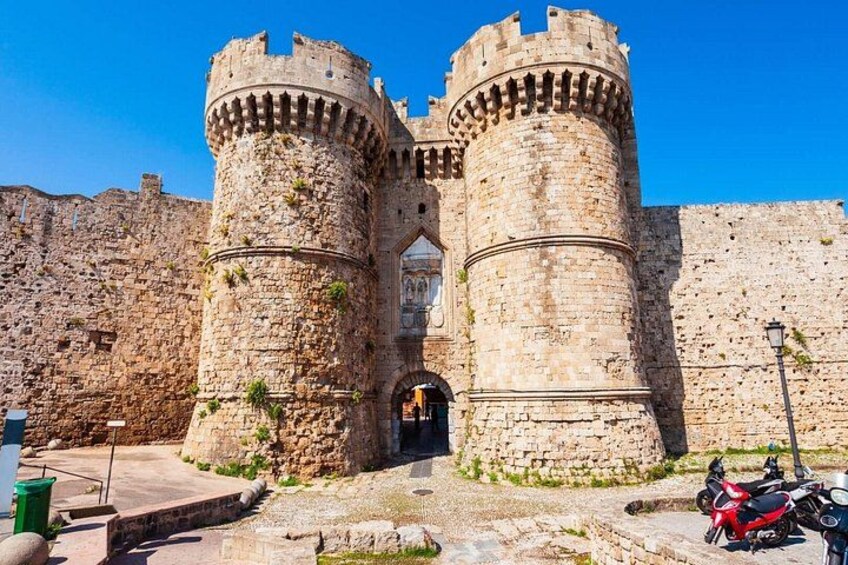 A historic stone castle with two prominent towers and a central entrance. 3