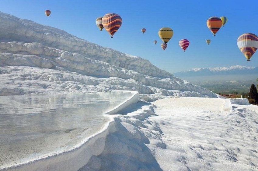 A snowy landscape with hot air balloons. 1