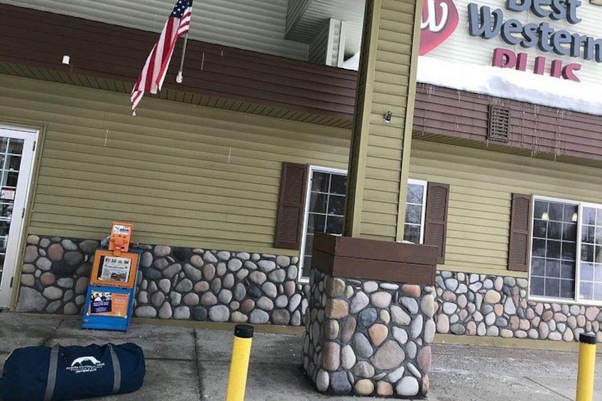 A building with a stone facade, an American flag, and a sign that reads 'Best Western Plus.' 2