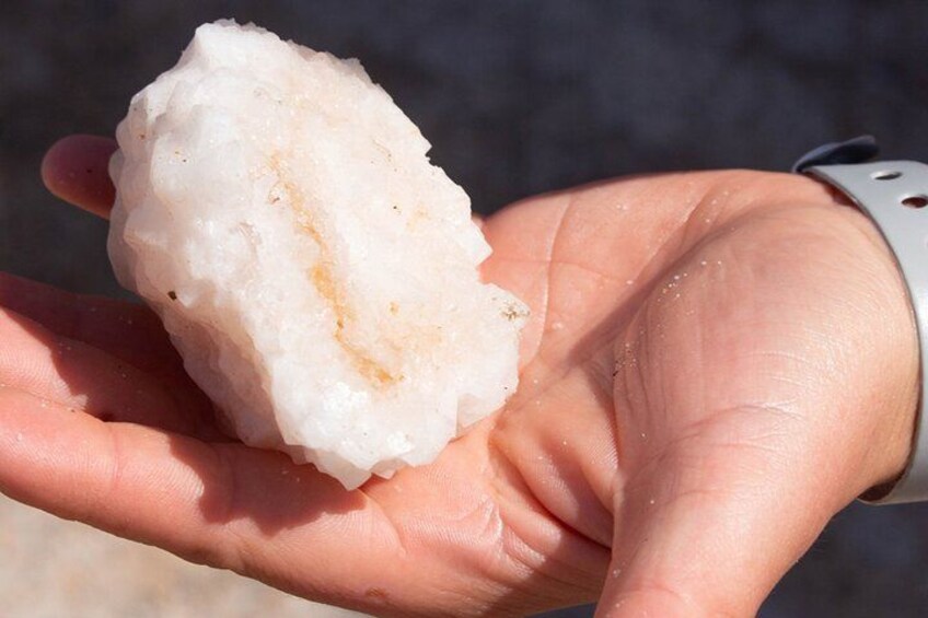 A hand holding a white, irregularly shaped object. 4