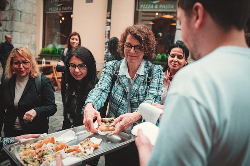 People serving food at an outdoor event. 2
