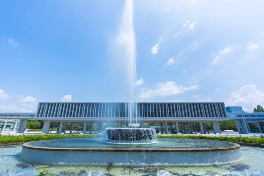 A fountain with water jets in front of a modern building. 2