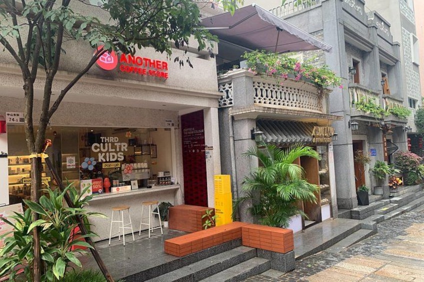 A coffee shop named 'Another Coffee Shop' with outdoor seating and a sign for 'Third Cult Kids.' 4