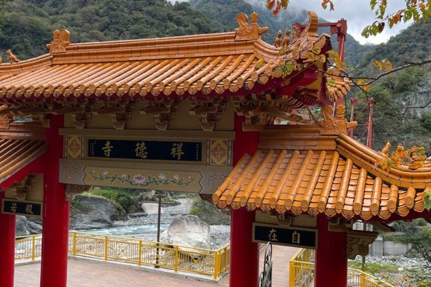 A traditional Chinese gate with intricate roof design and Chinese characters. 2