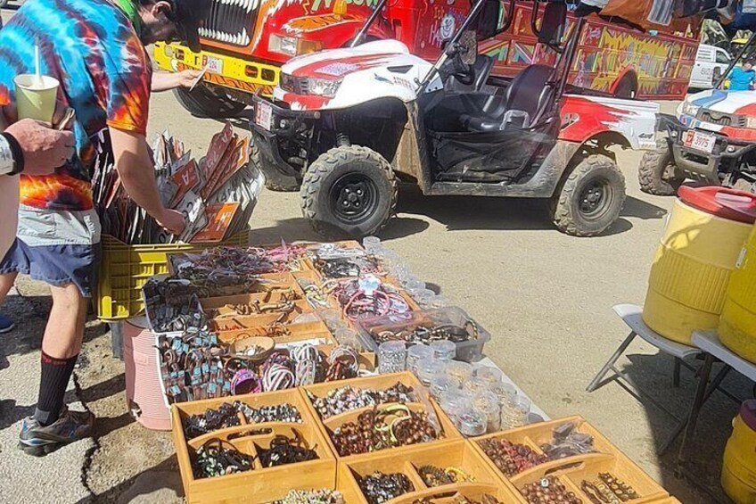 A market stall with various items for sale, including jewelry and accessories. 5