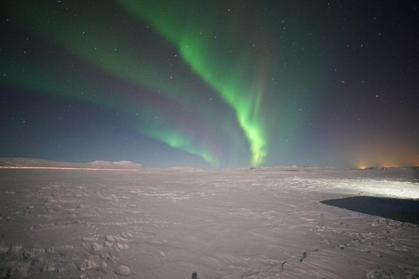 A snowy landscape with the Northern Lights. 3