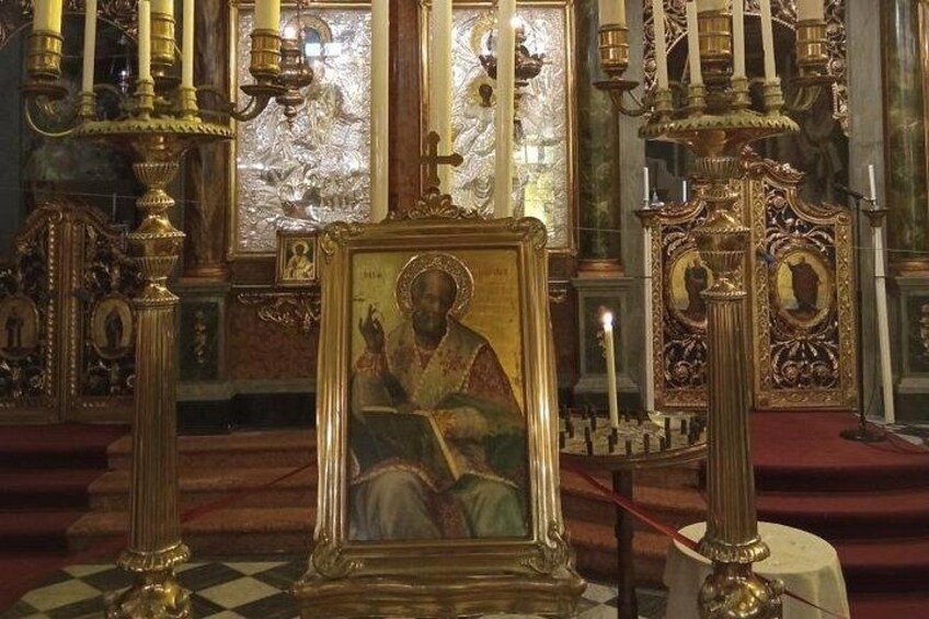 Ein religiöses Ikonostas mit aufwendigen Kerzenhaltern und einem gerahmten religiösen Gemälde. 5