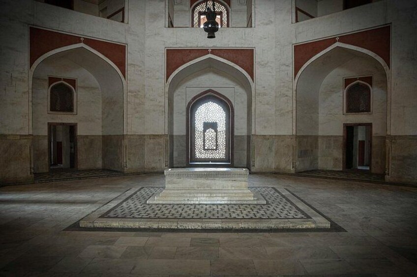 An interior with arched doorways and a central illuminated doorway. 3