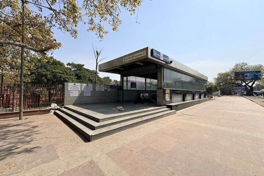 A modern building with a covered entrance and steps leading up to it. 2
