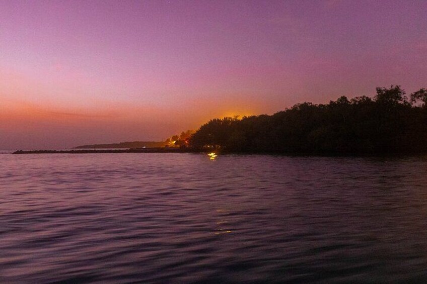 A sunset over a body of water with a distant shoreline. 4