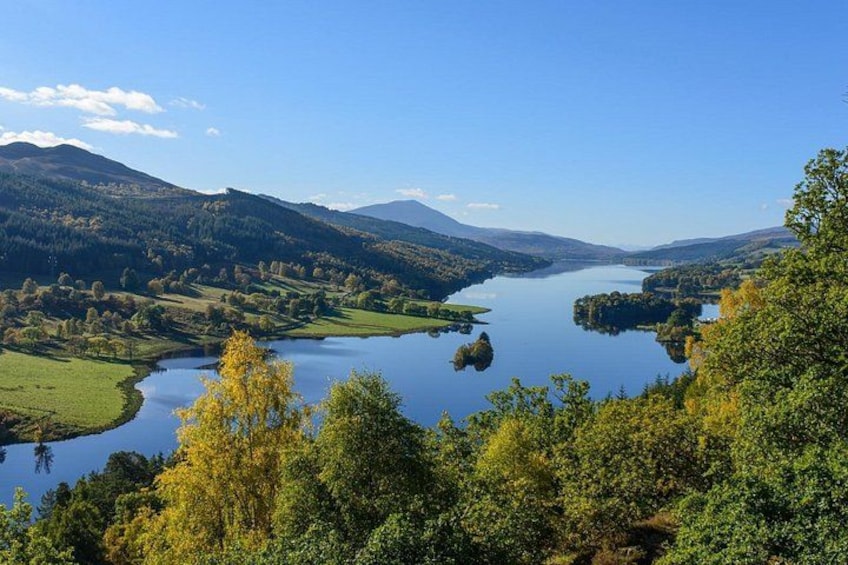 A lake surrounded by hills and trees. 4