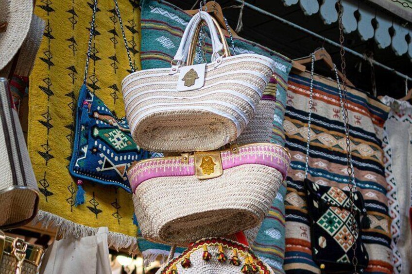 A variety of woven bags and textiles displayed for sale. 5