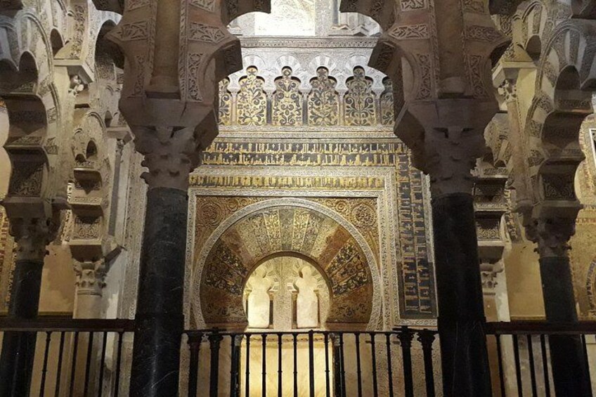 An ornate architectural archway with intricate carvings and a decorative ceiling. 5