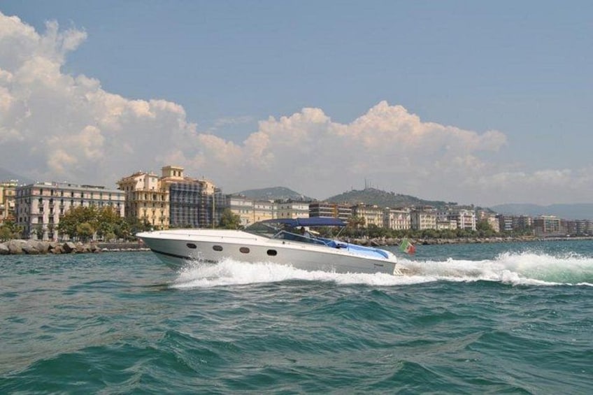 Un velero en el agua con un paisaje urbano de fondo. 5