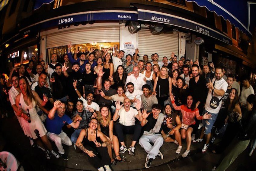 A group of people gathered in front of a store named 'Lipsos' with a hashtag '#artbir' visible on the sign. 4