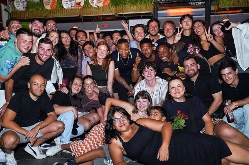 A group of people posing for a photo in an indoor setting with a casual atmosphere. 3