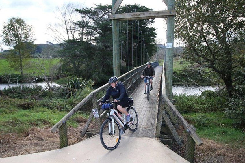 A wooden bridge with cyclists riding over it. 4