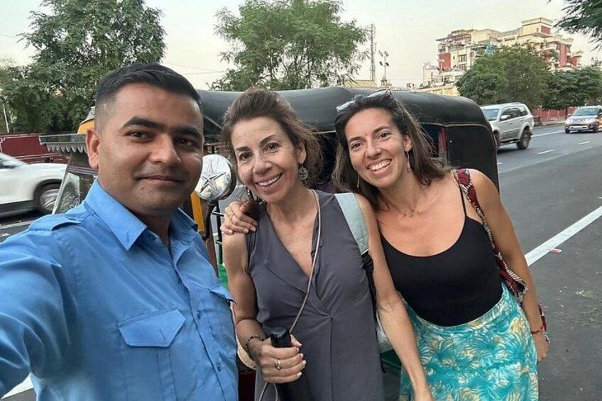Three people taking a selfie with a tuk-tuk in the background. 5