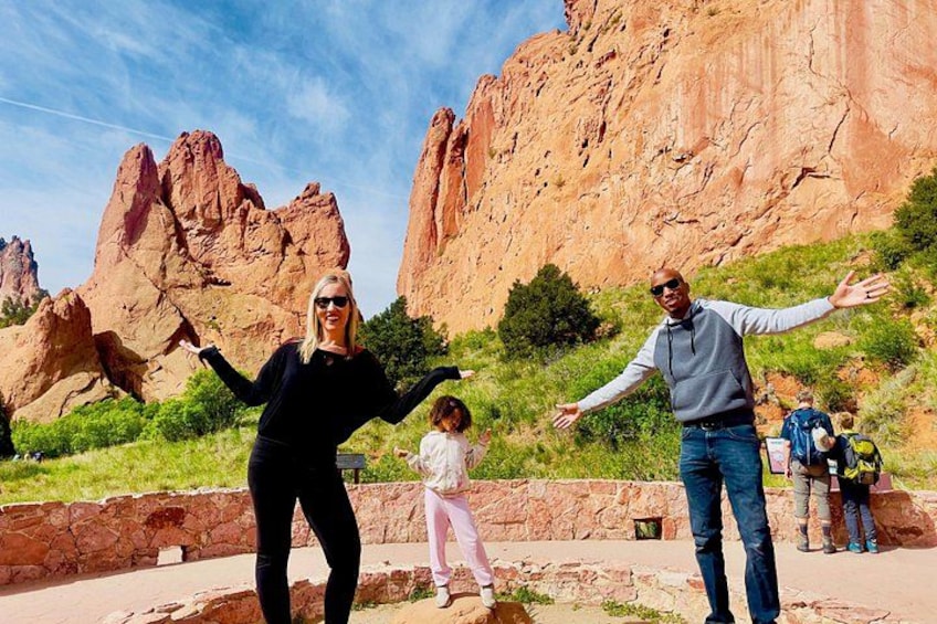 A family with a child in a natural landscape with red rock formations. 5