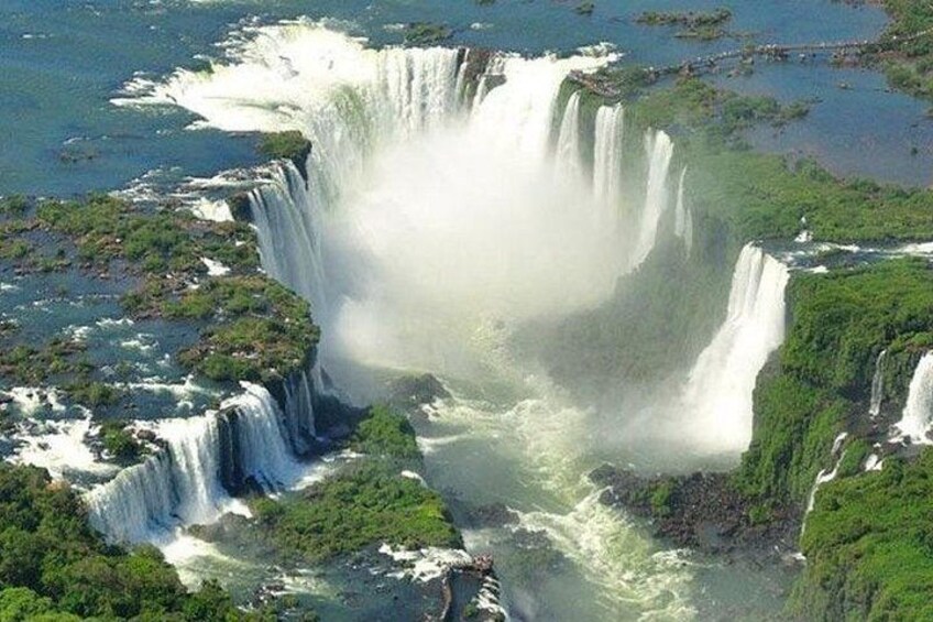 Una cascada grande rodeada de vegetación exuberante. 5