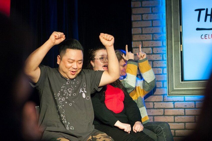 A person sitting on a couch with their arms raised. 5